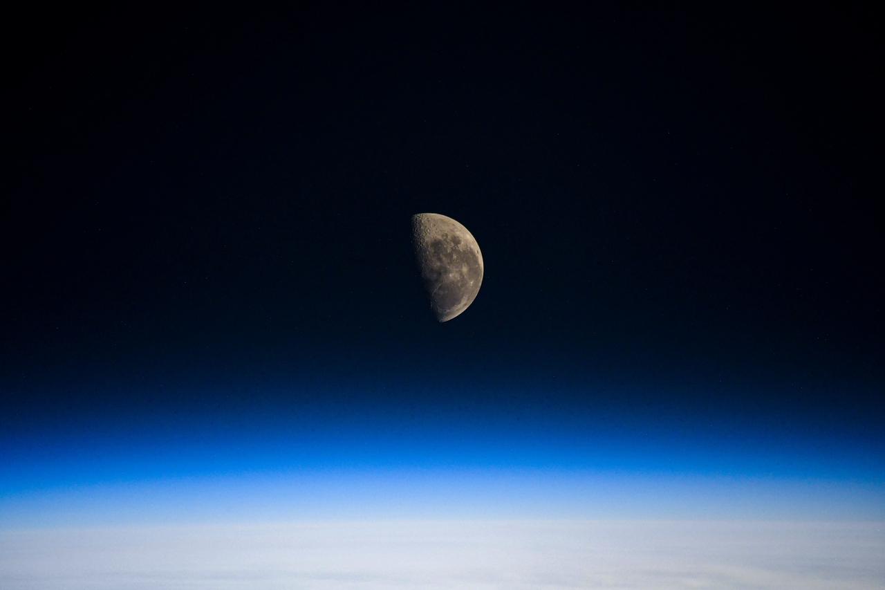 iss064e040717 (March 5, 2021) --- The Last Quarter Moon is pictured above the Earth's horizon as the International Space Station orbited 273 miles over the Indian Ocean in between Australia and Antarctica.