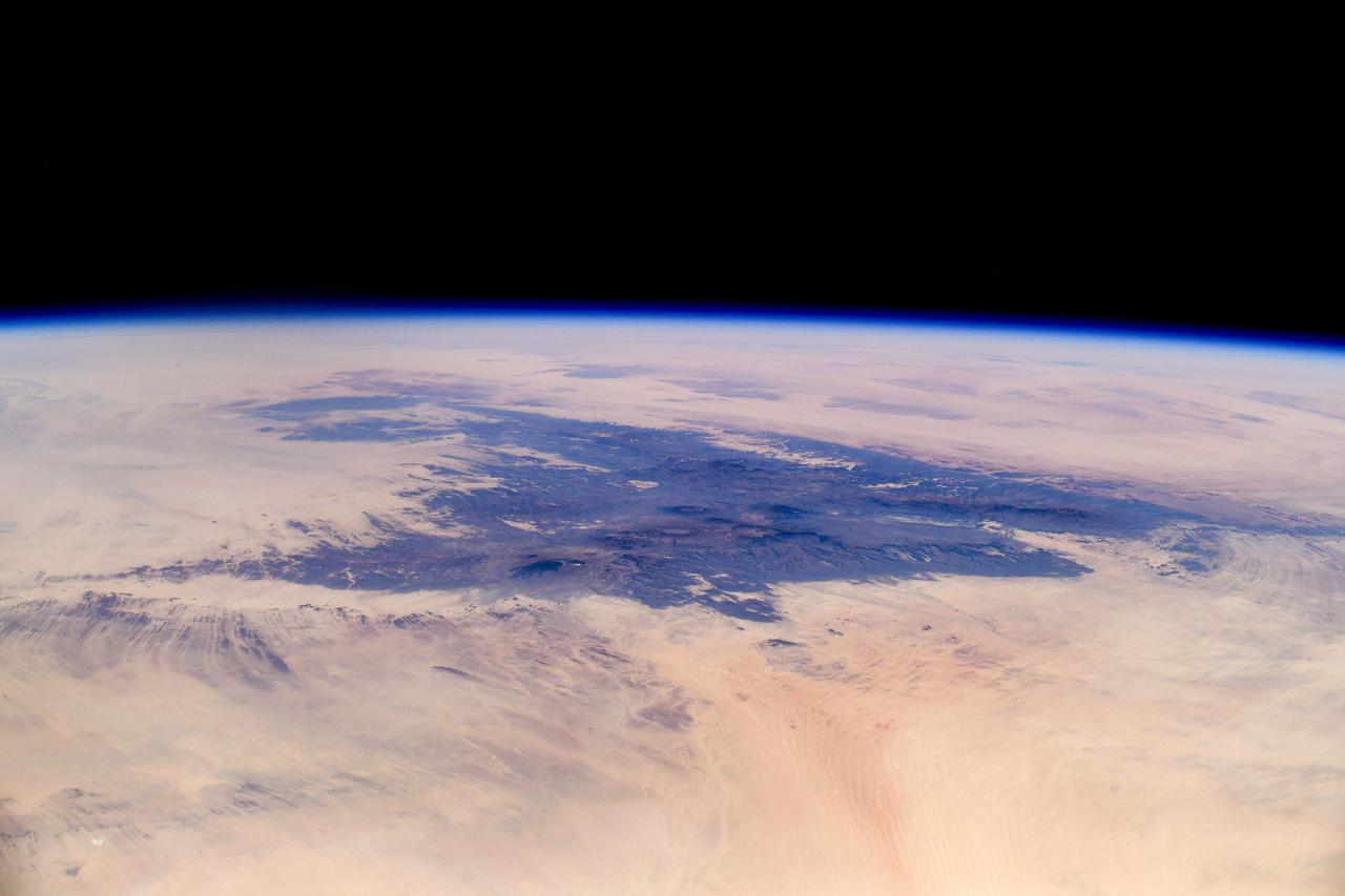 iss064e040726 (March 5, 2021) --- This picture from the International Space Station orbiting 261 miles above Africa looks northeast across Niger to the Tibesti Mountains of Chad. Credit: Roscosmos