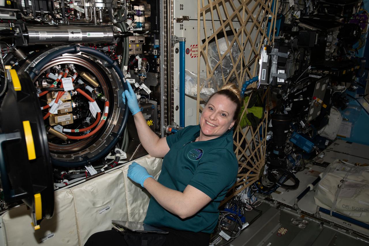 iss064e040971 (March 9, 2021) --- NASA astronaut and Expedition 64 Flight Engineer Kate Rubins opens the Combustion Integrated Rack's combustion chamber to access ACME, or Advanced Combustion via Microgravity Experiments, hardware located in the U.S. Destiny laboratory module.