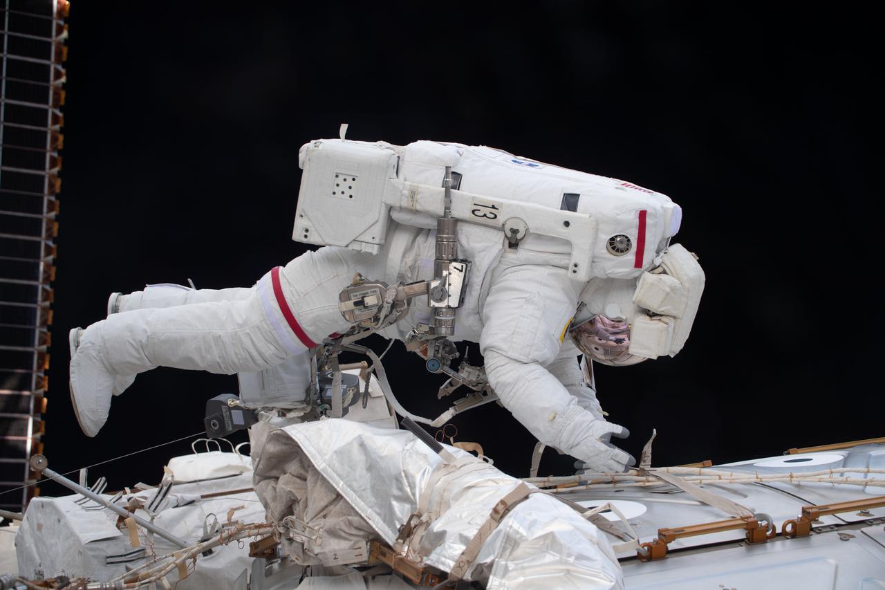 iss064e041816 (March 13, 2021) --- NASA astronaut and Expedition 64 Flight Engineer Victor Glover is pictured during a spacewalk to service the station’s cooling system and communications gear with fellow NASA spacewalker Michael Hopkins (out of frame).