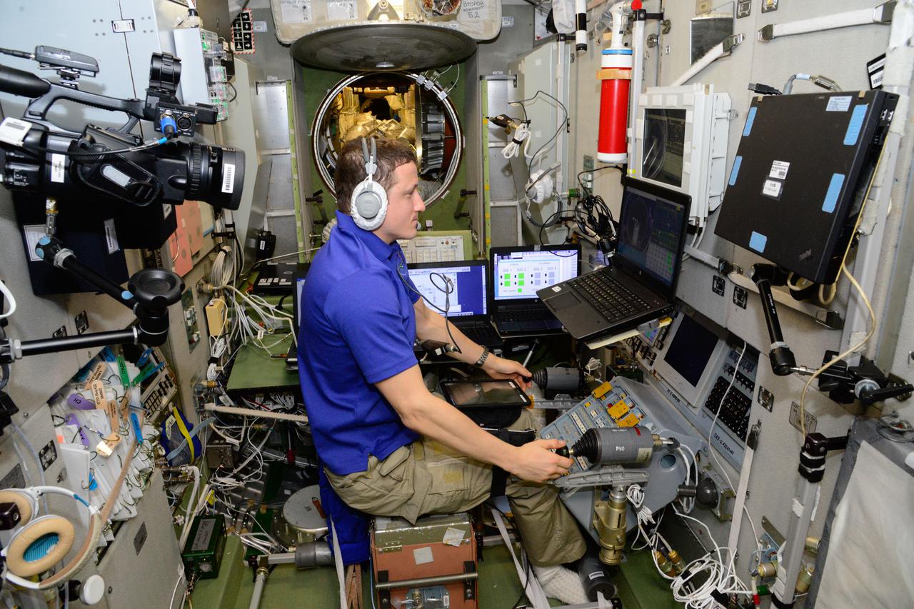 iss064e043771 (March 16, 2021) --- Roscosmos cosmonaut and Expedition 64 Flight Engineer Sergey Kud-Sverchkov, from inside the Zvezda service module, practices on a computer the relocation of the Soyuz MS-17 crew ship from the Rassvet module to the Poisk module.