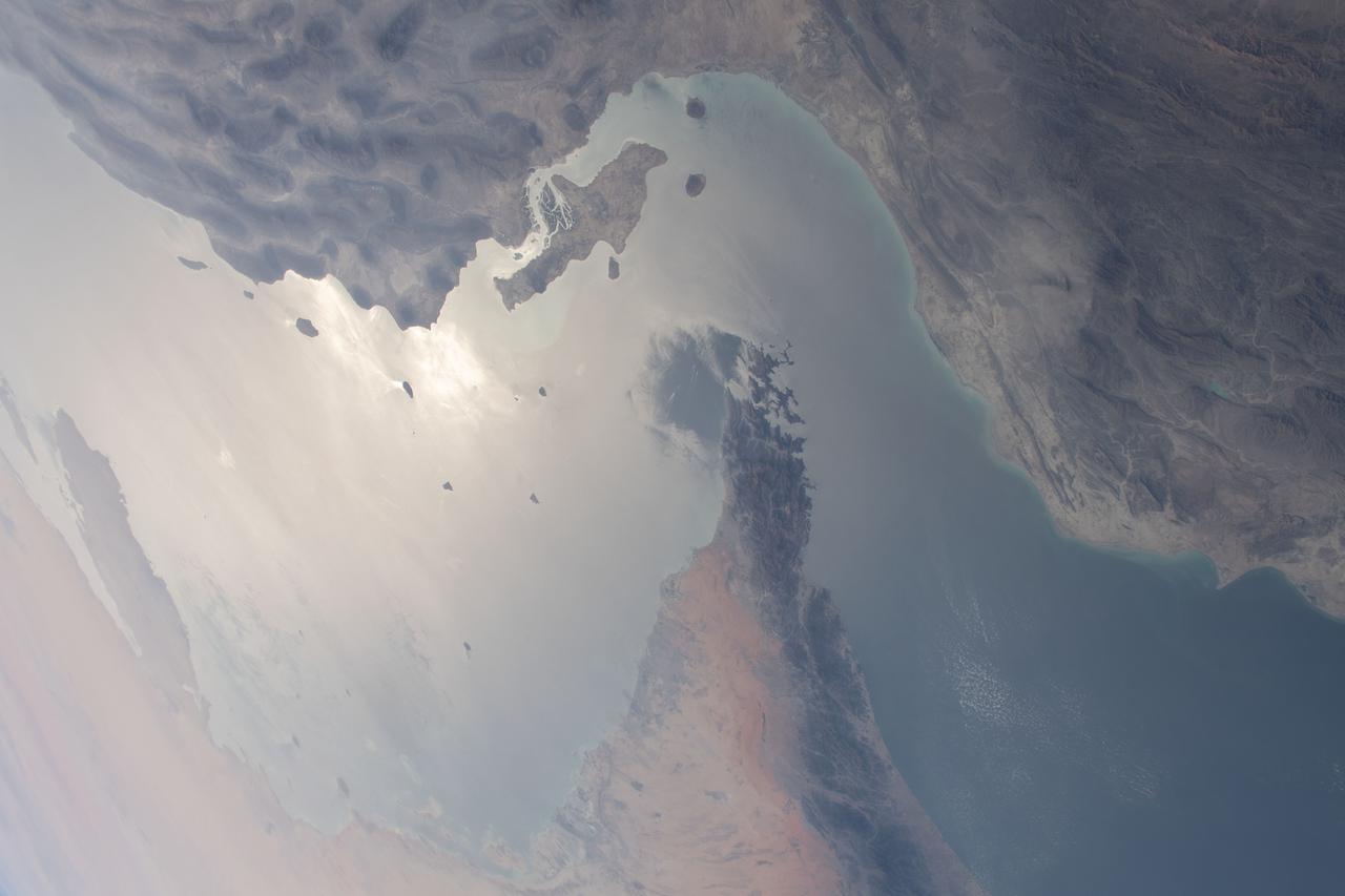 iss064e046338 (March 24, 2021) --- The strategically important shipping route of the Strait of Hormuz is pictured separating the nations of the United Arab Emirates and Iran. It also separates the main water bodies of the Persian Gulf and the Gulf of Oman.