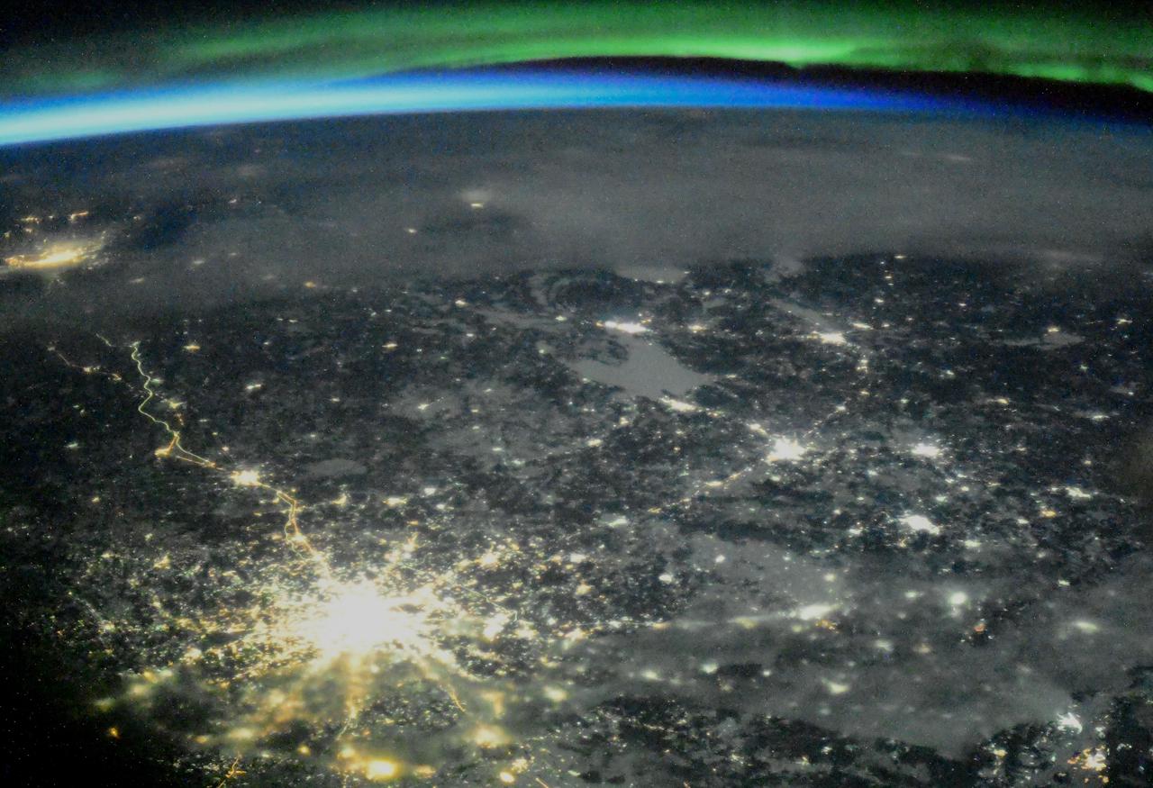 iss064e046345 (March 23, 2021) --- The night lights of Moscow, Russia, are accented by an orbital sunset and an aurora as the International Space Station orbited 265 miles above the Ukrainian-Russian border.