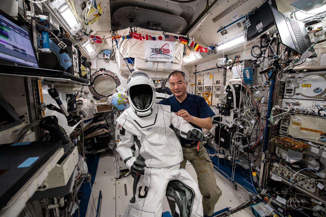 iss064e049824 (March 31, 2021) --- Astronaut Soichi Noguchi of the Japan Aerospace Exploration Agency poses with his SpaceX Crew Dragon spacesuit inside the International Space Station's Kibo laboratory module.