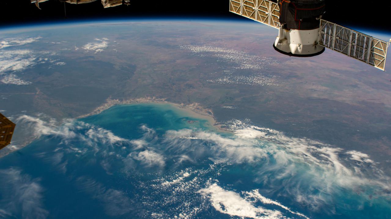 iss064e051879 (April 3, 2021) --- The Gulf of Carpentaria in northern Australia is pictured from the International Space Station as it orbited 264 miles above the Arafura Sea near the Indonesian province of Papua. At the top right, is the aft-end of the ISS Progress 77 resupply ship docked to the Pirs docking compartment.