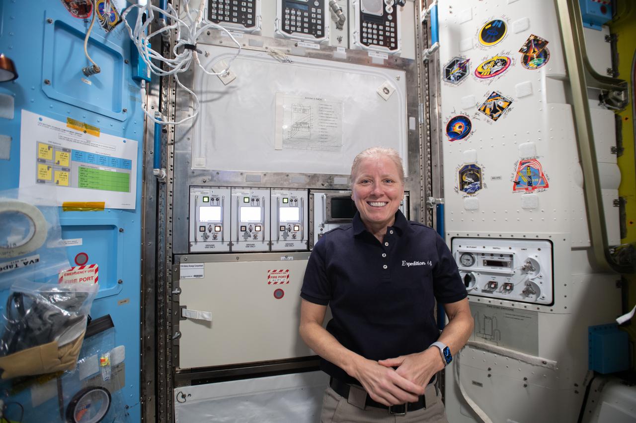 iss064e053473 (April 7, 2021) --- NASA astronaut and Expedition 64 Flight Engineer Shannon Walker poses for a portrait inside the U.S. Quest airlock that is normally filled with U.S. spacesuit components when spacewalks are planned at the International Space Station.