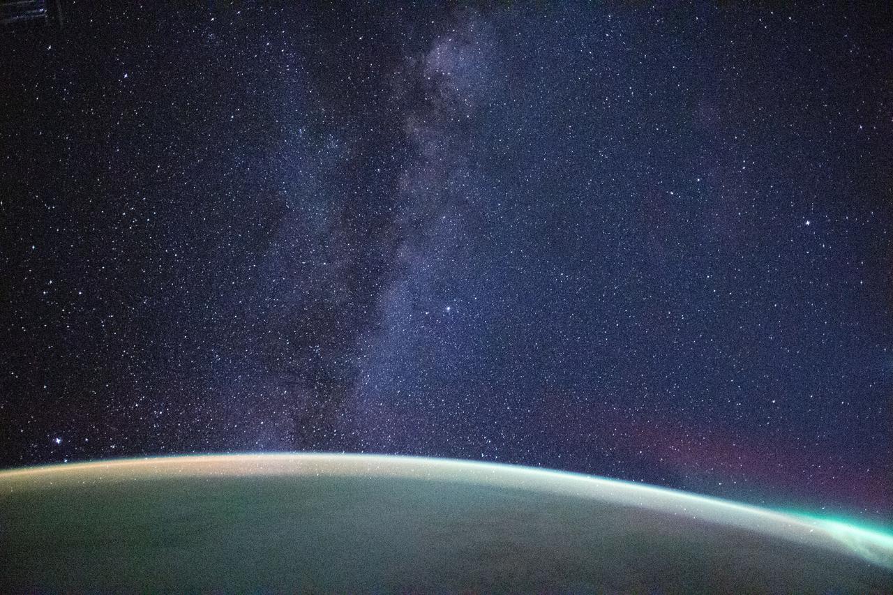 iss064e055946 (April 8, 2021) --- This long exposure photograph was taken during an orbital night period from the International Space Station 271 miles above the Indian Ocean. The Milky Way extends above the airglow blanketing the Earth's horizon with an aurora near the bottom right of the frame.