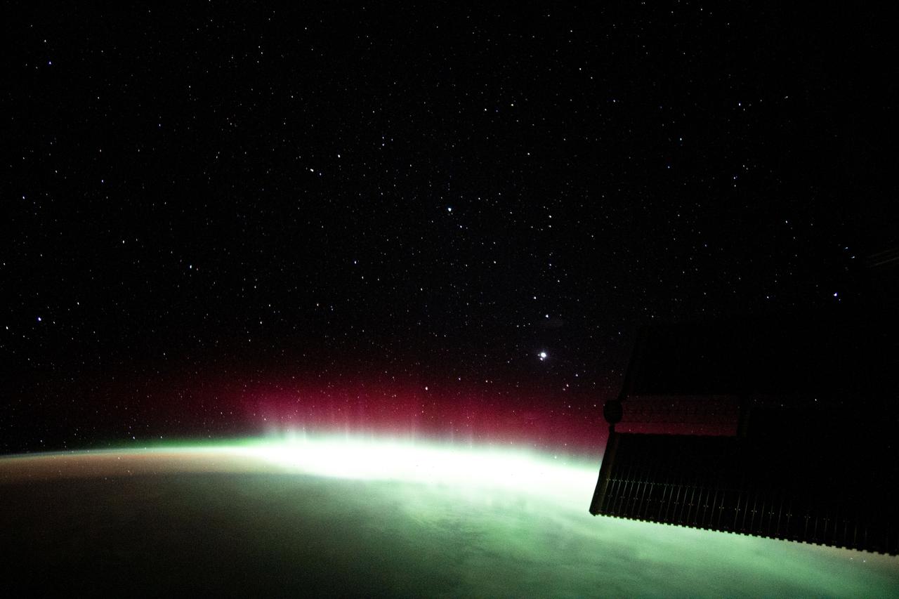 iss065e001061 (April 17, 2021) --- An aurora is pictured streaming above the Earth from a window aboard the SpaceX Crew Dragon Resilience. The International Space Station was orbiting 271 miles above the Indian Ocean in between South Africa and Antarctica.