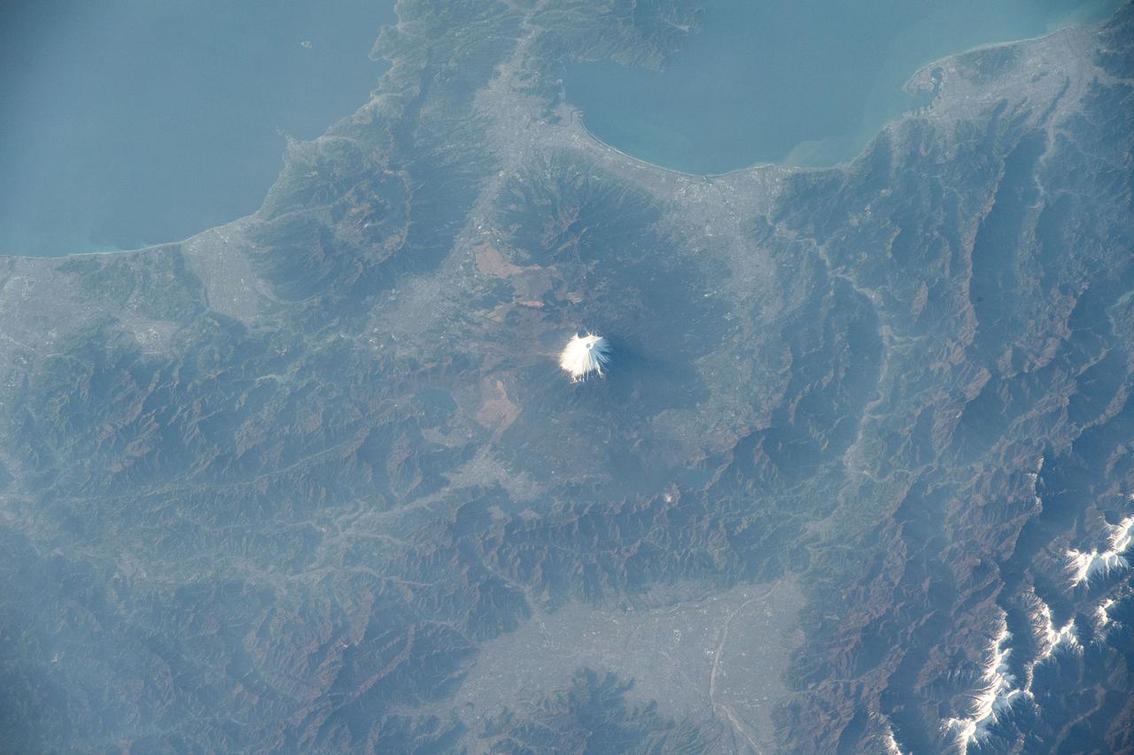 iss065e001158 (April 19, 2021) --- Mount Fuji, north of Suruga Bay and west of Tokyo, is pictured from the International Space Station as it orbited 264 miles above the Sea of Japan.
