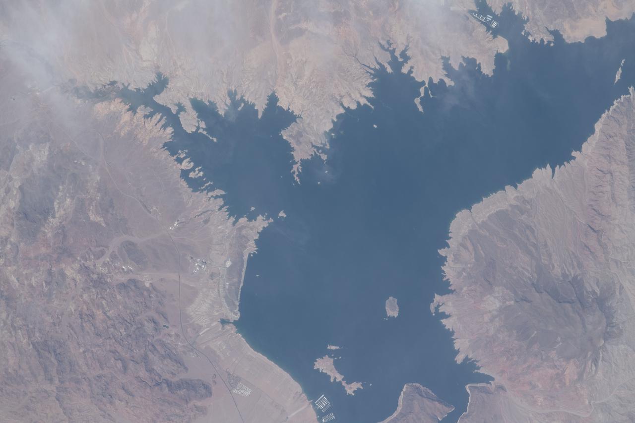 iss065e001327 (April 20, 2021) --- The Colorado River, pictured from the International Space Station at an altitude of 263 miles, separates Arizona from Nevada. The smaller body of water at center left is Las Vegas Bay.