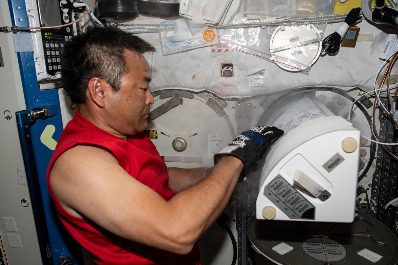 iss065e008243 (April 28, 2021) --- Japan Aerospace Exploration Agency (JAXA) astronaut and Expedition 65 Flight Engineer Akihiko Hoshide opens a science freezer inside the U.S. Destiny laboratory module aboard the International Space Station.