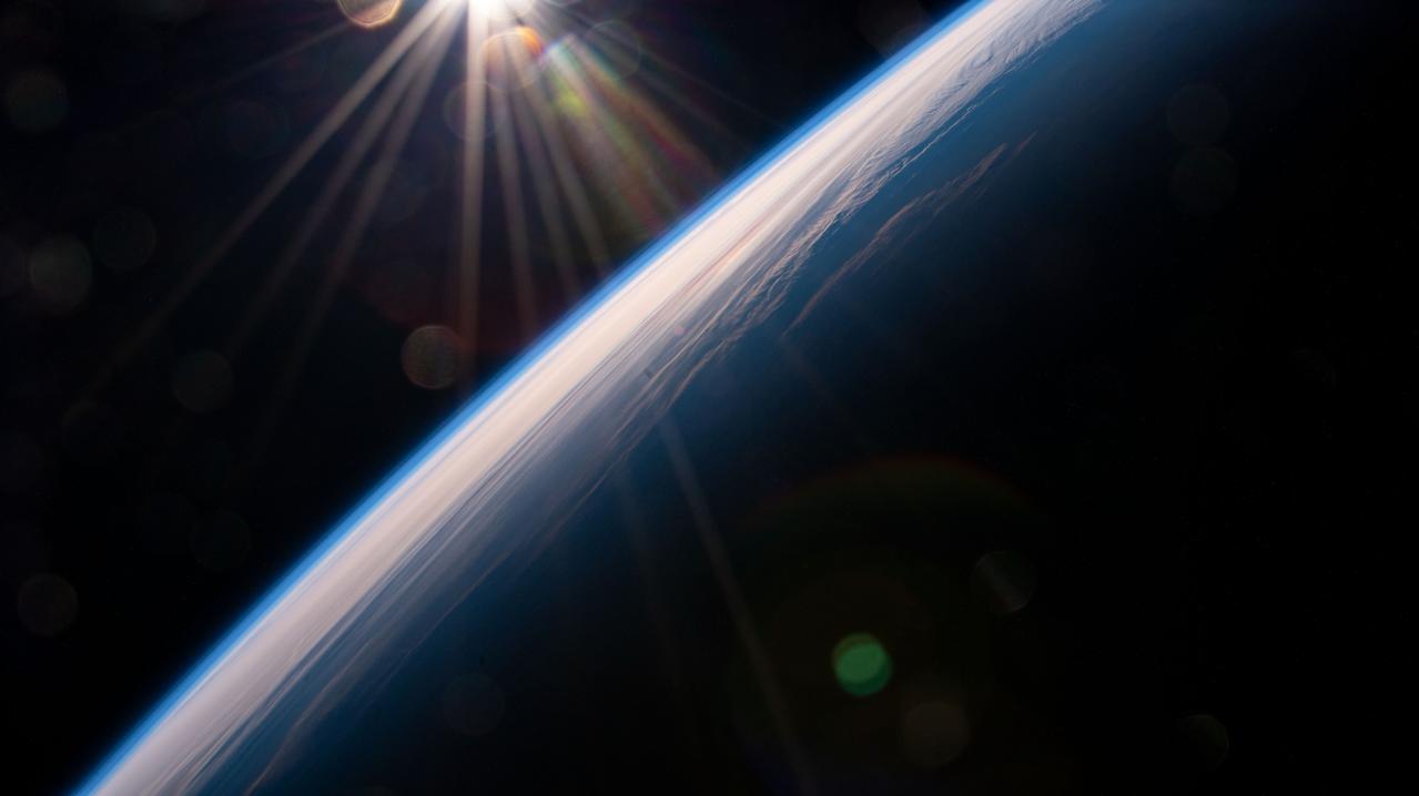 iss065e009306 (April 28, 2021) --- The International Space Station flies into an orbital sunrise 264 miles above far eastern China near the the Sea of Japan.