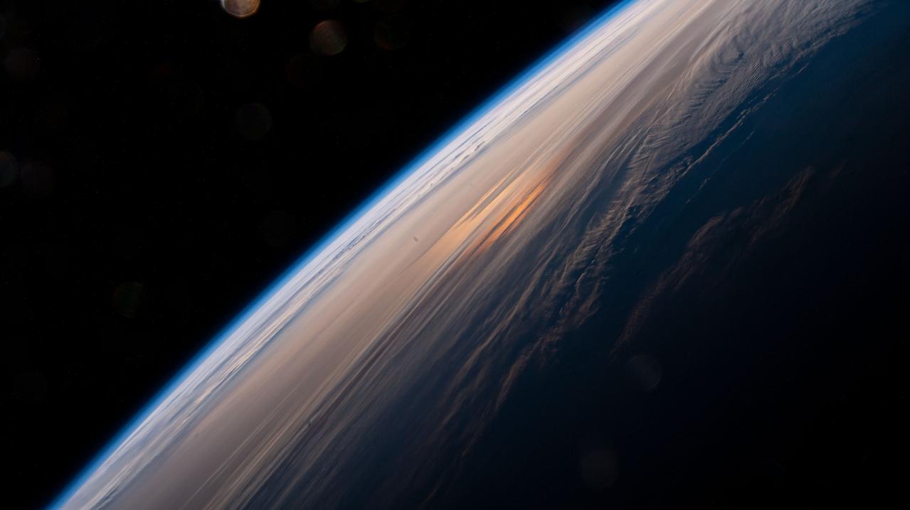 iss065e009307 (April 28, 2021) --- The early morning hues of an orbital sunrise are pictured from the International Space Station as it soared 264 miles above the China-Russia border in far eastern Asia near the the Sea of Japan.