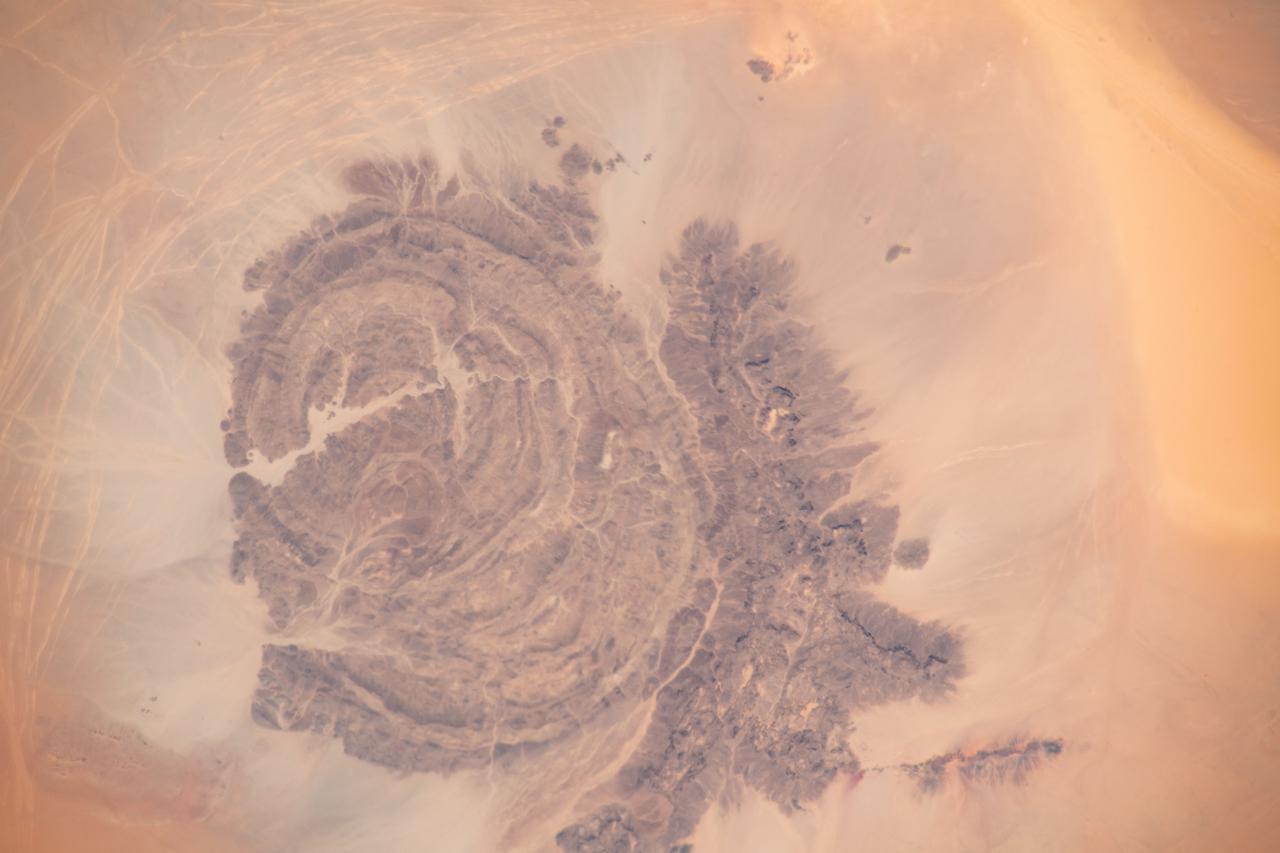 iss065e009521 (April 29, 2021) --- Mount Arkanu in southeast Libya, near the border with Egypt and Sudan, is pictured from the International Space Station as it orbited 262 miles above the Sahara Desert.