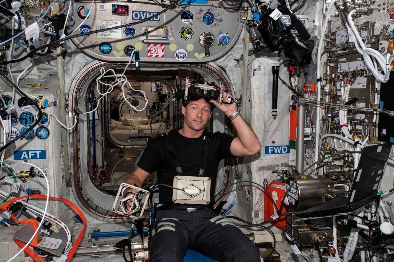 iss065e009555 (April 29, 2021) --- ESA (European Space Agency) astronaut and Expedition Flight Engineer Thomas Pesquet is seated inside the Columbus laboratory module for the GRASP experiment. The central nervous system investigation requires an astronaut to wear a virtual reality headset and reach toward virtual objects to help scientists understand how the brain adapts to microgravity.