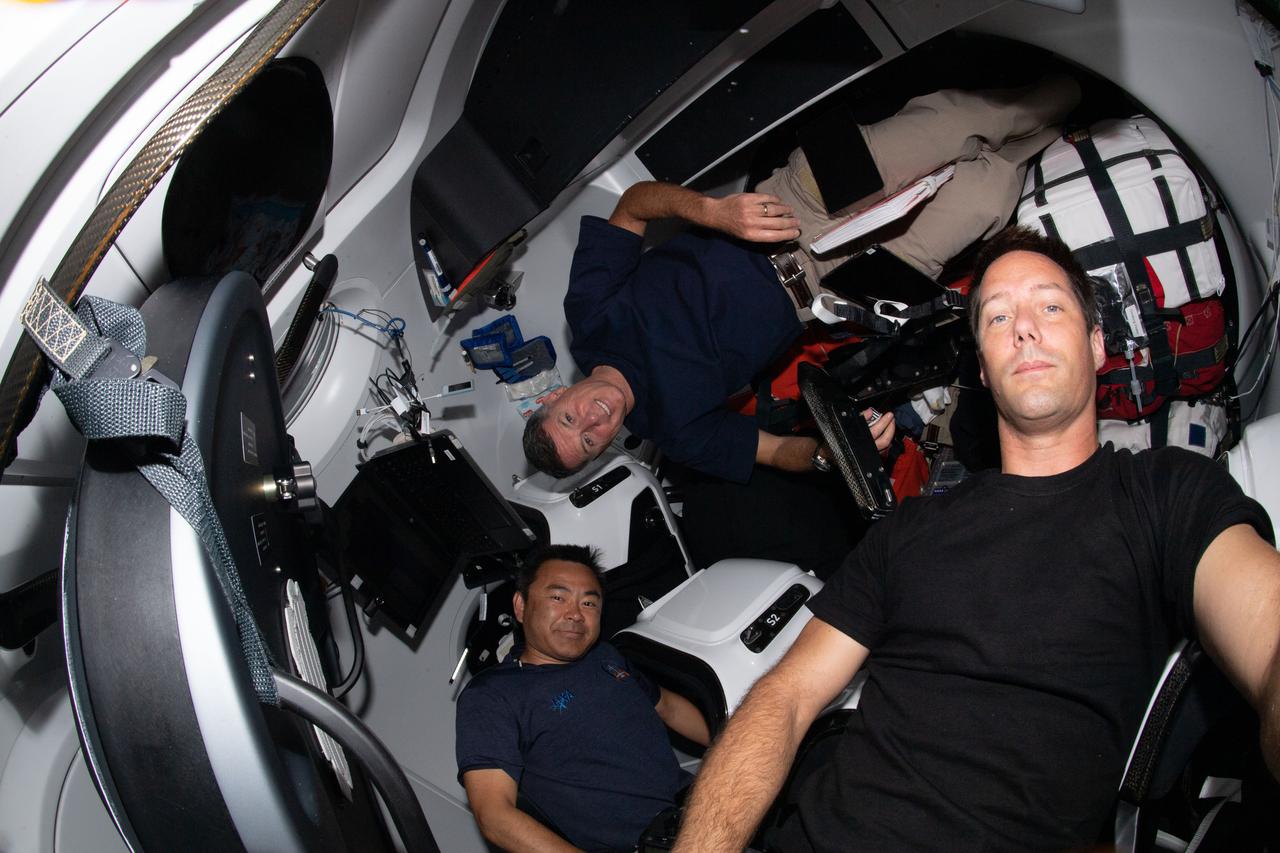 iss065e011900 (April 30, 2021) --- Astronauts (clockwise from bottom) Akihiko Hoshide of the Japan Aerospace Exploration Agency, Shane Kimbrough of NASA and Thomas Pesquet of ESA (European Space Agency) are pictured inside the SpaceX Crew Dragon Resilience.