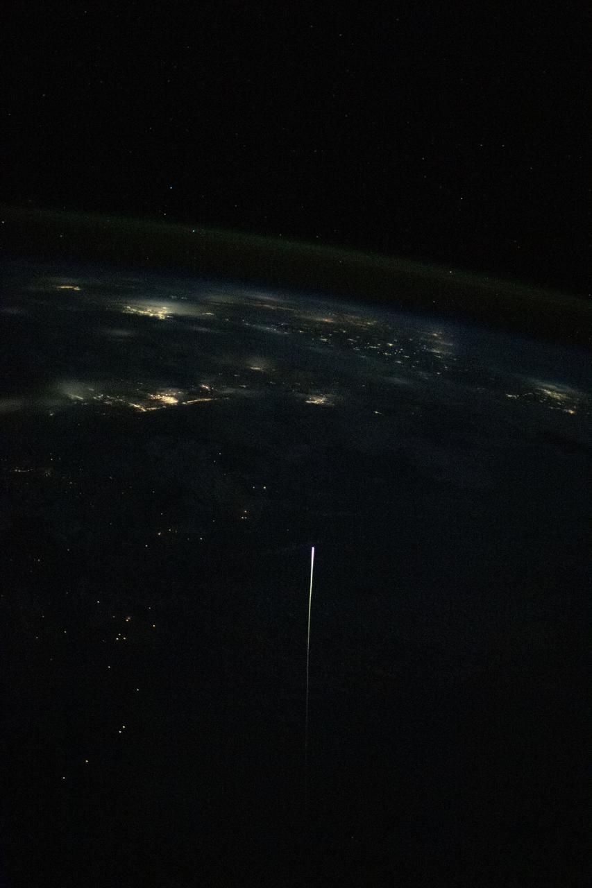 iss065e012265 (May 2, 2021) --- The SpaceX Crew Dragon Resilience is pictured from the International Space Station reentering Earth's atmosphere. Resilience, with its protective heat shield, reached the atmosphere at over 17,000 miles per hour experiencing friction and extreme heat creating a visible plasma trail streaming behind it. Astronauts Michael Hopkins, Victor Glover, Shannon Walker and Soichi Noguchi would safely parachute to a splashdown inside Resilience a few minutes later in the Gulf of Mexico off the coast of Panama City, Florida.