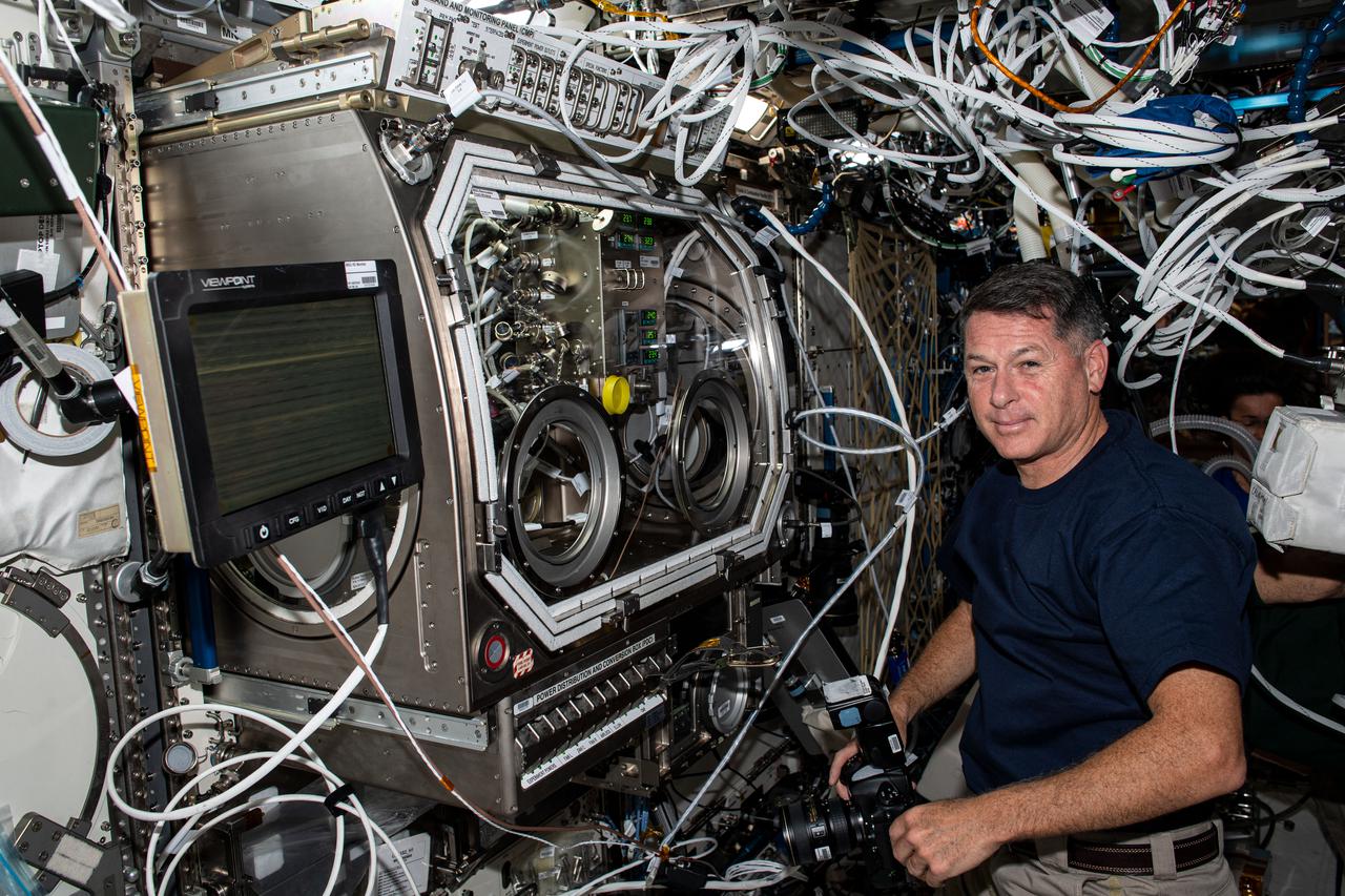 iss065e020575 (May 6, 2021) --- NASA astronaut and Expedition 65 Flight Engineer Shane Kimbrough sets up the  U.S. Destiny laboratory module's Microgravity Science Glovebox for a physics investigation. The study known as Solidification Using a Baffle in Sealed Ampoules, or SUBSA, explores improving technology used in producing semiconductor crystals.