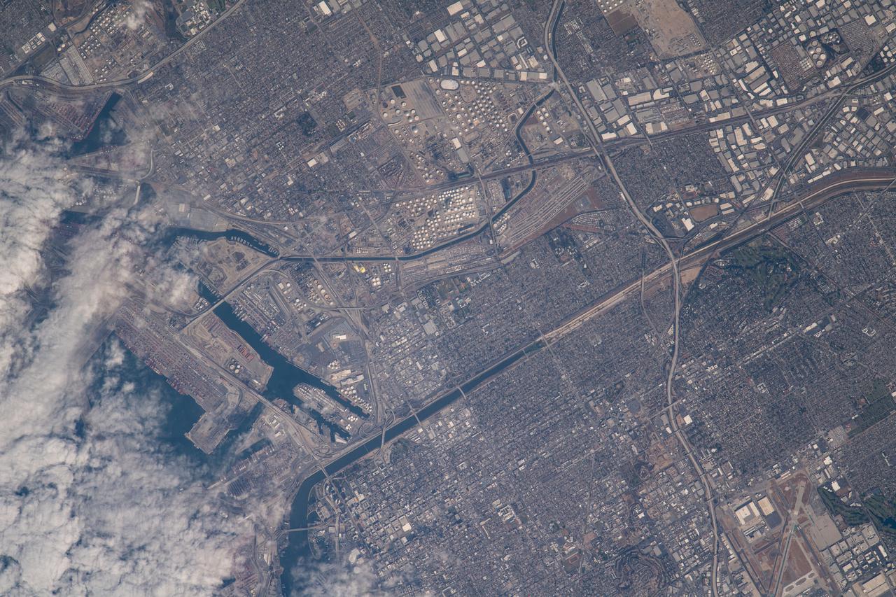 iss065e021010 (May 5, 2021) --- A cloud-covered Terminal Island and Long Beach south of Los Angeles, California, is pictured from the International Space Station as it orbited 263 miles above the Pacific Ocean off the coast of San Diego.
