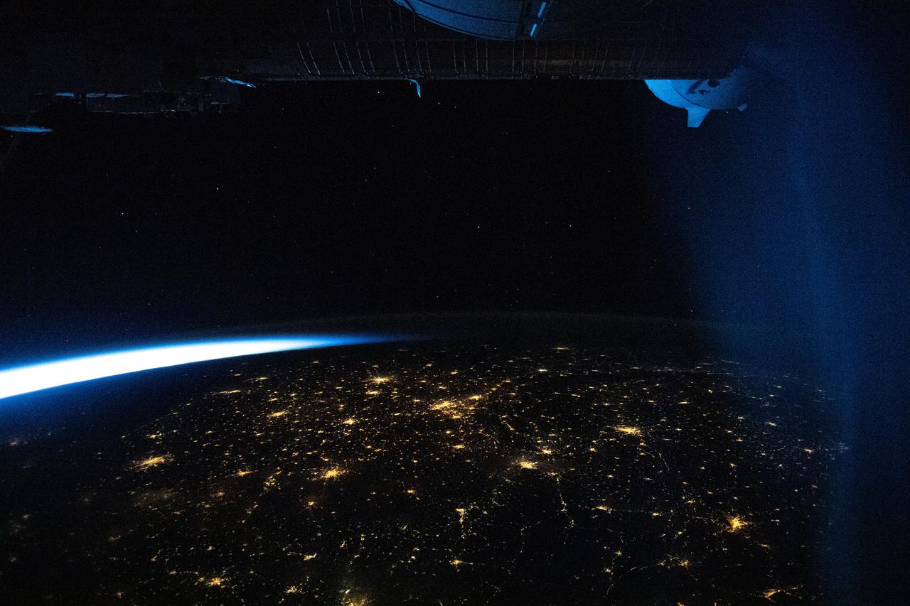 iss065e029349 (May 9, 2021) --- An orbital twilight fades over the city lights of Europe as the International Space Station soared 263 miles above southern France. At upper right, is the docked SpaceX Crew Dragon Endeavour.