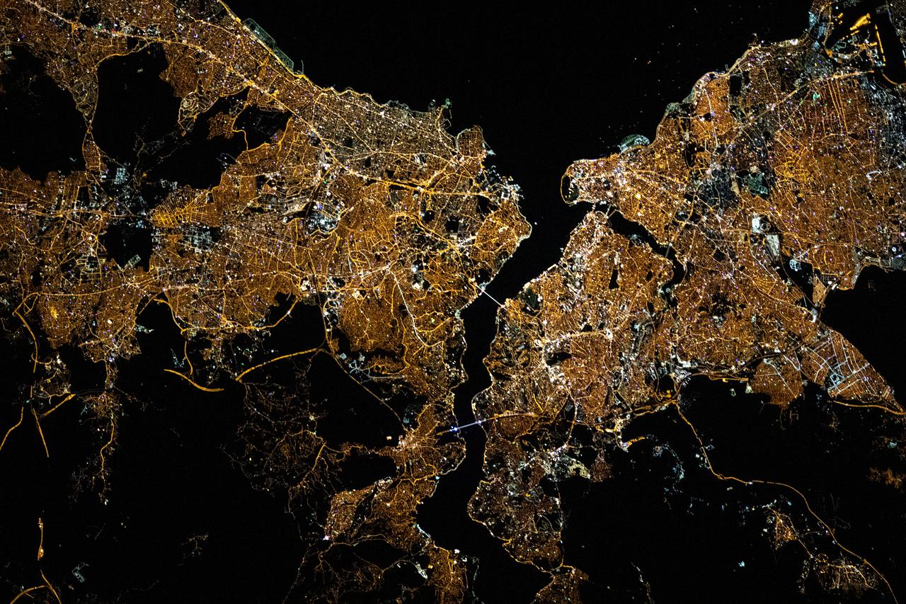iss065e030820 (May 10, 2021) --- The night lights of Istanbul, Turkey, split by the Bosphorus Strait and the Golden Horn, are pictured from the International Space Station as it orbited 263 miles above the Black Sea.