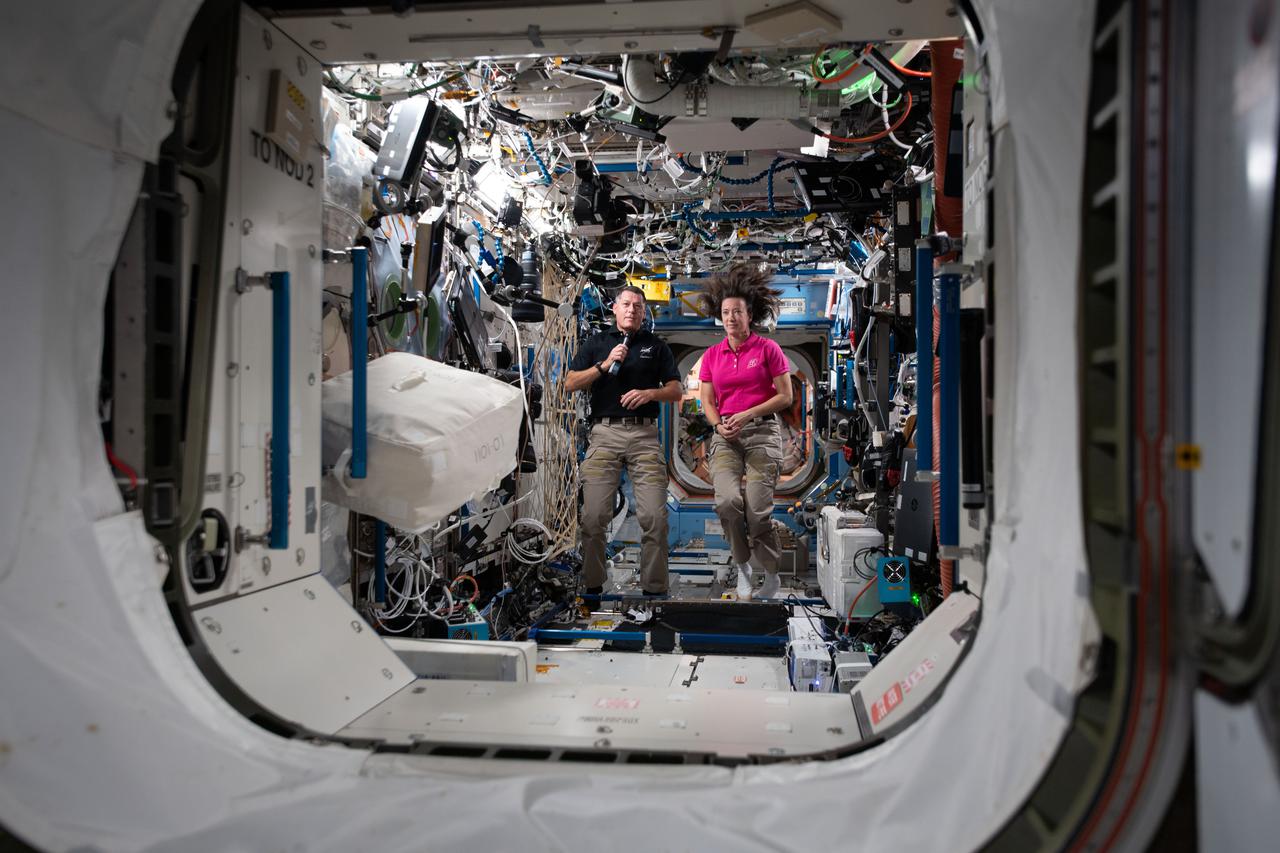 iss065e045799 (May 14, 2021) --- NASA astronauts and Expedition 65 Flight Engineers Shane Kimbrough and Megan McArthur are pictured inside the U.S. Destiny laboratory module participating in interviews with journalists on the ground.