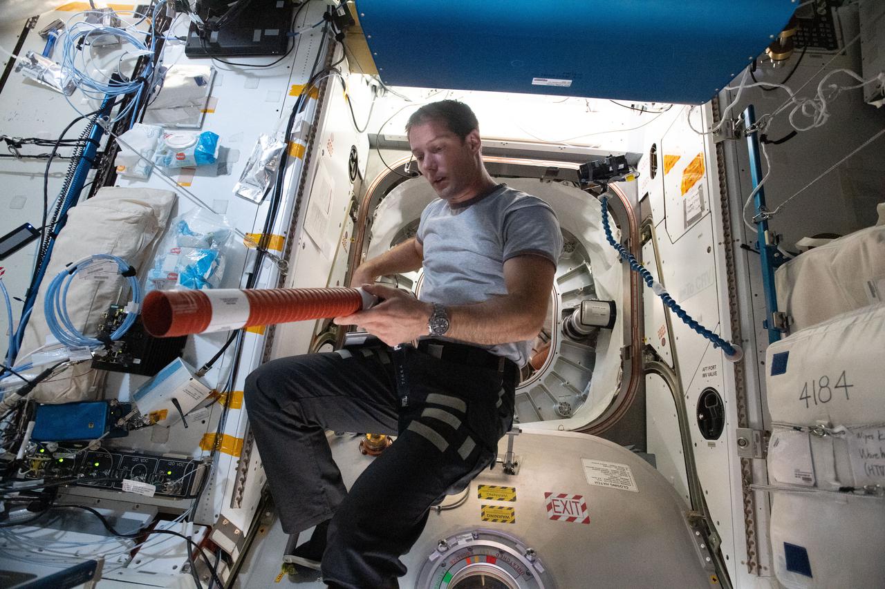 iss065e045918 (May 17, 2021) --- Expedition 65 Flight Engineer Thomas Pesquet of ESA (European Space Agency) is pictured inside the International Space Station's Tranquility module during maintenance work in front of the entrance to BEAM, the Bigelow Expandable Activity Module.