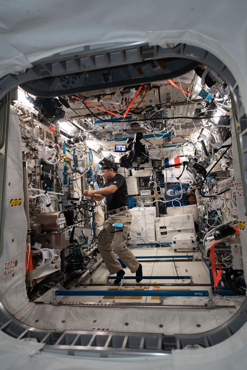 iss065e048413 (May 19, 2021) --- Expedition 65 Commander Akihiko Hoshide of the Japan Aerospace Exploration Agency is pictured inside the Columbus laboratory module wrapping up activities for the Time Perception experiment. During the investigation a crew member wears a virtual reality headset and clicks on a trackball to explore how astronauts perceive time and space which may impact navigation and fine motor coordination in microgravity.