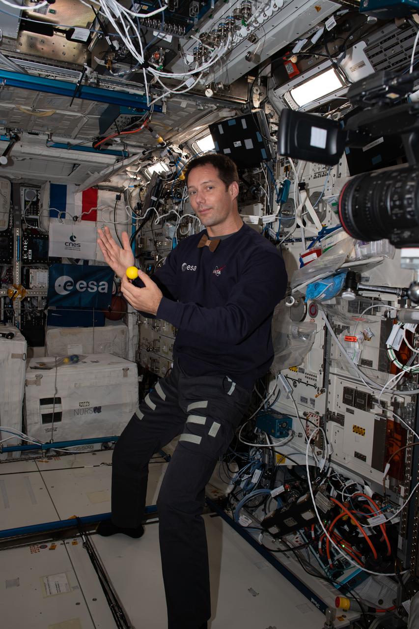 iss065e050323 (May 21, 2021) --- Expedition 65 Flight Engineer Thomas Pesquet of ESA (European Space Agency) performs magic tracks for the Illusion educational study. The experiment sponsored by ESA illustrates how visual perception and the central nervous system is impacted in microgravity.