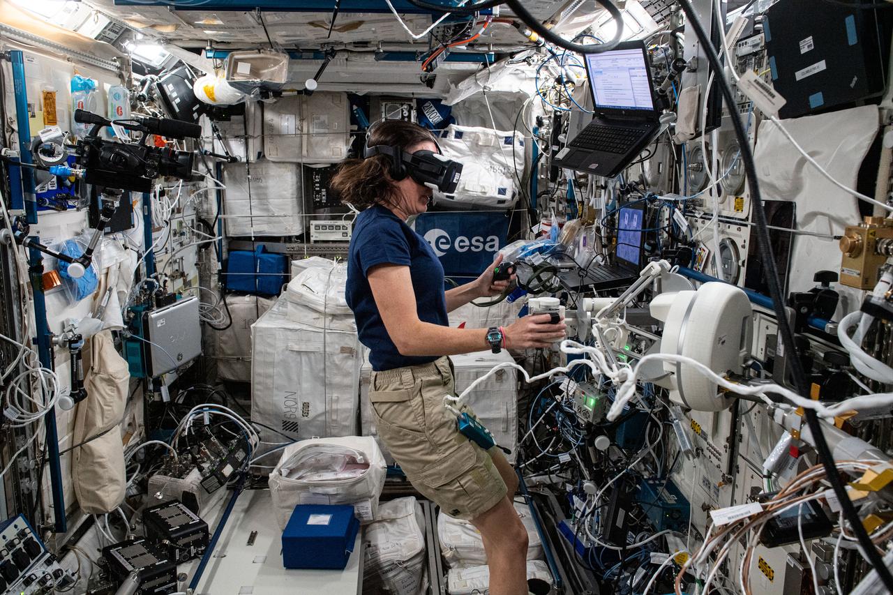ss065e073985 (May 26, 2021) --- NASA astronaut Megan McArthur participate in the Pilote experiment. The experiment from the European Space Agency uses virtual reality gear and tests a crew member’s aptitude when maneuvering a computer-generated robotic arm toward a target. Results may influence the design of workstations and interfaces for future spacecraft and space habitats.