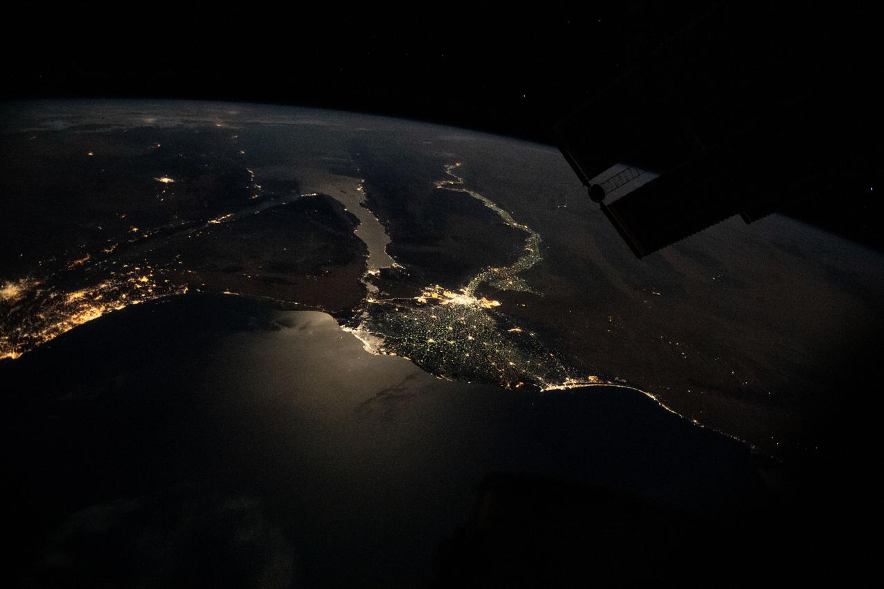 iss065e074560 (May 20, 2021) --- This nighttime photograph, taken from the International Space Station as it orbited 263 miles above Turkey, highlights the Moon's glint on the Mediterranean Sea and the Gulf of Suez. The city lights along the Nile Delta and the eastern Mediterranean coast also figure prominently in the picture.