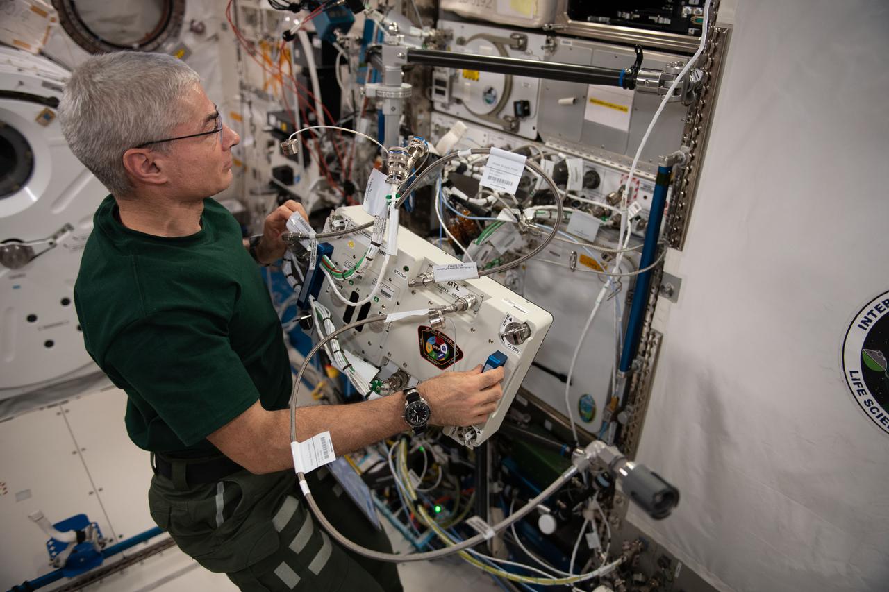 iss065e081498 (May 28, 2021) --- NASA astronaut and Expedition 65 Flight Engineer Mark Vande Hei works to relocate the Multi-use Variable-g Platform (MVP) inside the Kibo laboratory module. The MVP is a space biology research platform that can produce up to 2 g of artificial gravity housing samples such as fruit flies, flatworms, plants, fish, cells, protein crystals and many others.