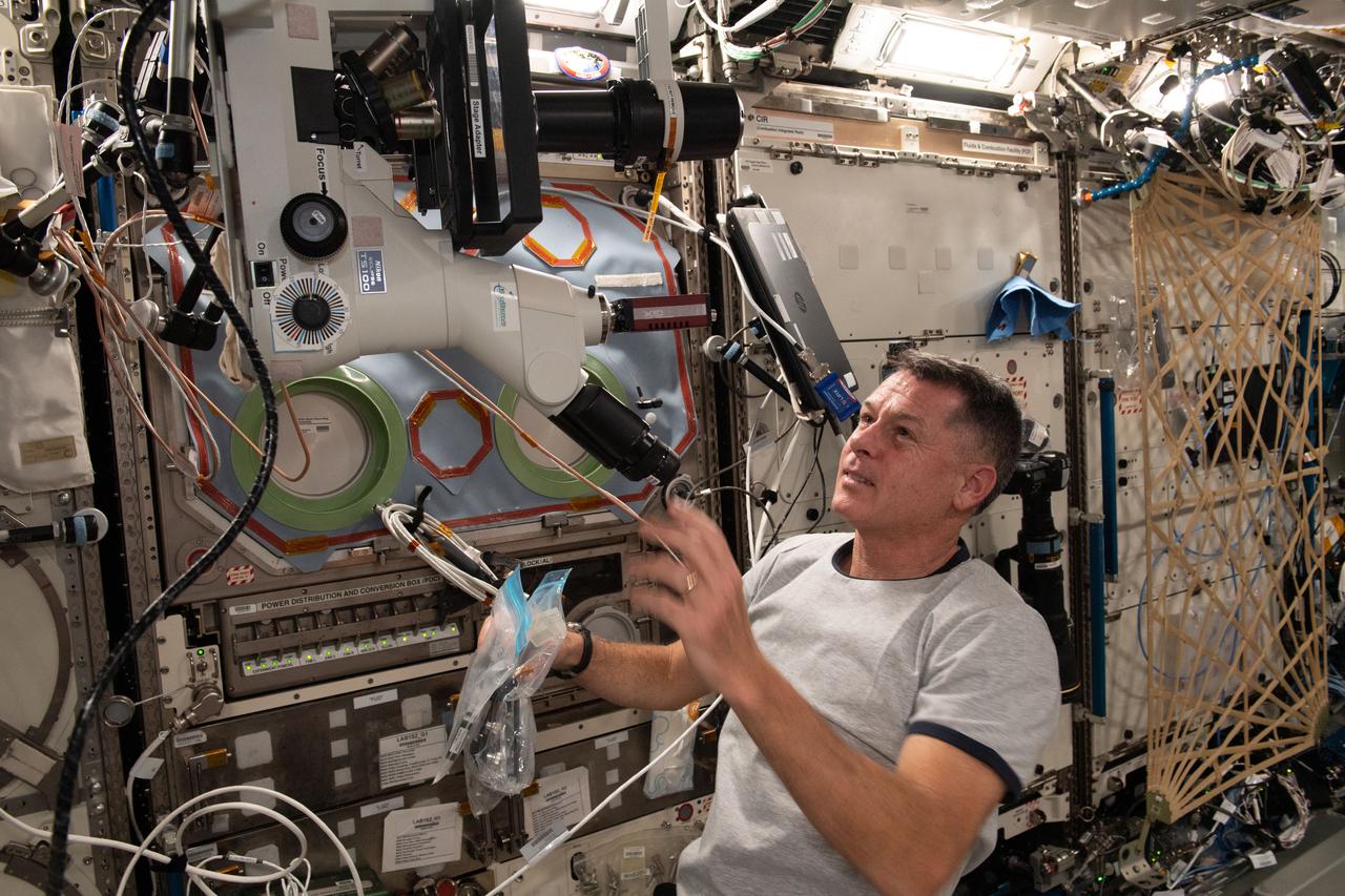 iss065e081518 (May 31, 2021) --- NASA astronaut and Expedition 65 Flight Engineer Shane Kimbrough sets up a microscope in the U.S. Destiny laboratory module to observe and photograph samples for the Real-Time Protein Crystal Growth experiment. Results have implications for biotechnology and pharmaceutical companies on Earth and may advance the commercialization of space.
