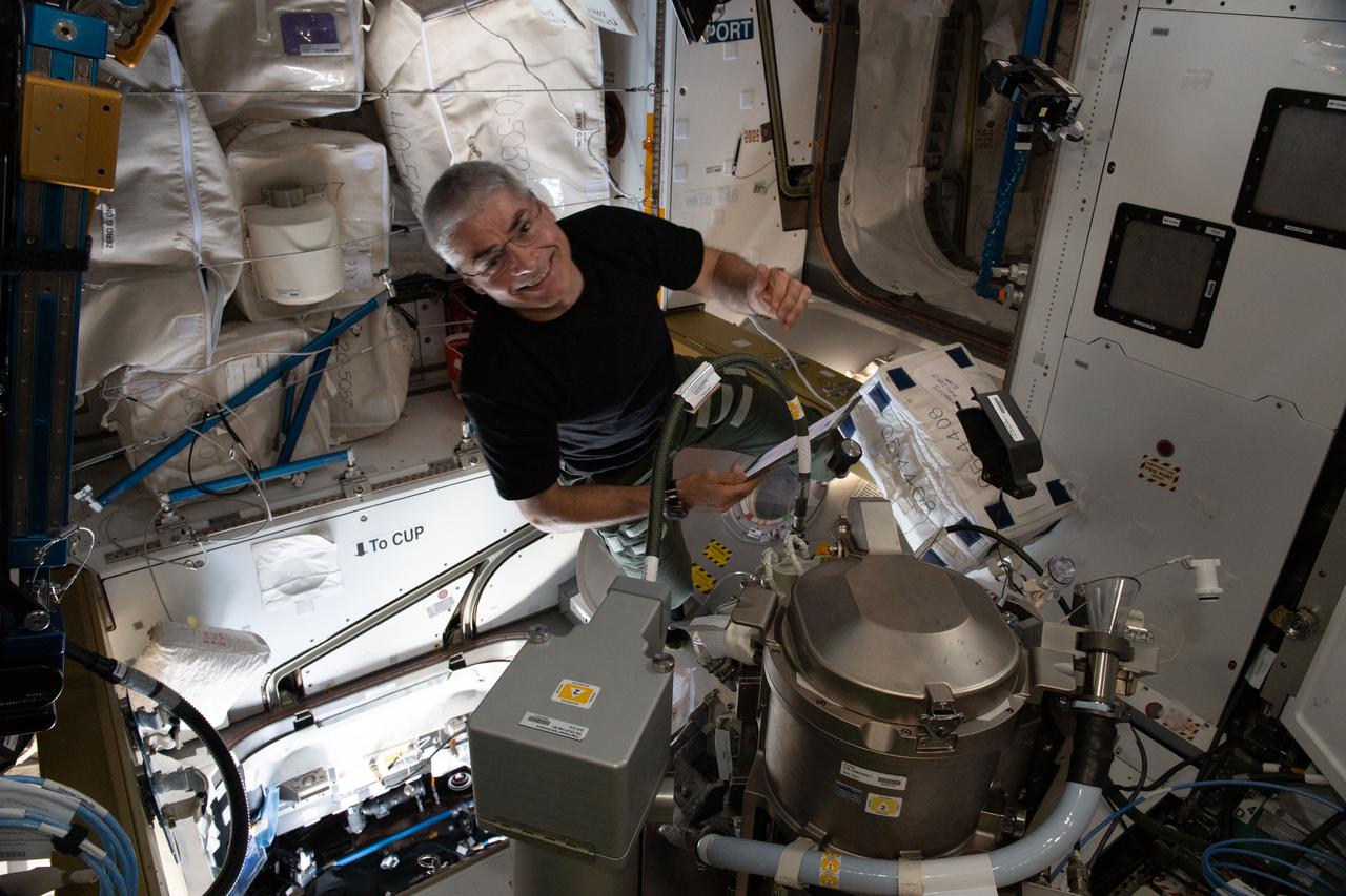 iss065e081532 (May 31, 2021) --- NASA astronaut and Expedition 65 Flight Engineer Mark Vande Hei swaps out components on an advanced new toilet installed inside the International Space Station's Tranquility module.