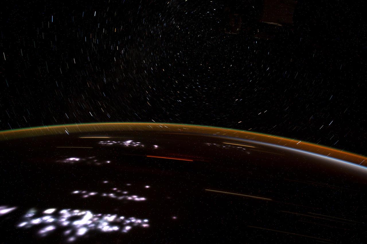 iss065e083929 (June 1, 2021) --- This long exposure photograph, taken from the International Space Station as it orbited 262 miles above the Democratic Republic of Congo, reveals city lights on the African continent, Earth's atmospheric glow and star trails.
