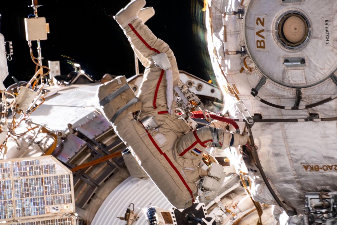 iss065e085268 (June 2, 2021) --- Expedition 65 Flight Engineer and Roscosmos cosmonaut Oleg Novitskiy is pictured during a seven-hour and 19-minute spacewalk to ready the Pirs docking compartment ahead of its upcoming departure. The Nauka multipurpose laboratory module, being launched soon from the Baikonur Cosmodrome in Kazakhstan, will replace Pirs on the Zvezda service module's Earth-facing port.