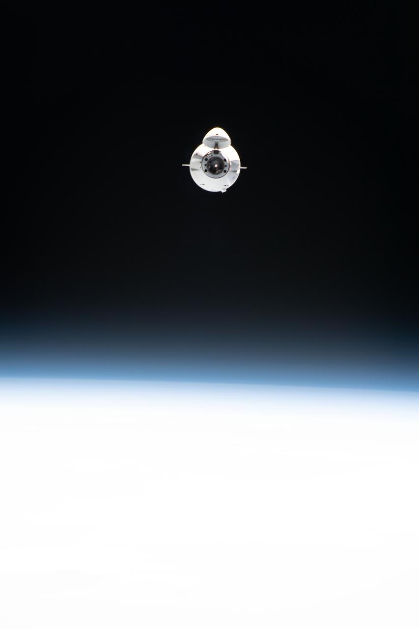 iss065e086842 (June 5, 2021) --- The SpaceX Cargo Dragon resupply ship is pictured approaching the International Space Station carrying over 7,300 pounds of new science, supplies and solar arrays to replenish the Expedition 65 crew. The Cargo Dragon's nose cone is open revealing its hatch and forward docking cone.