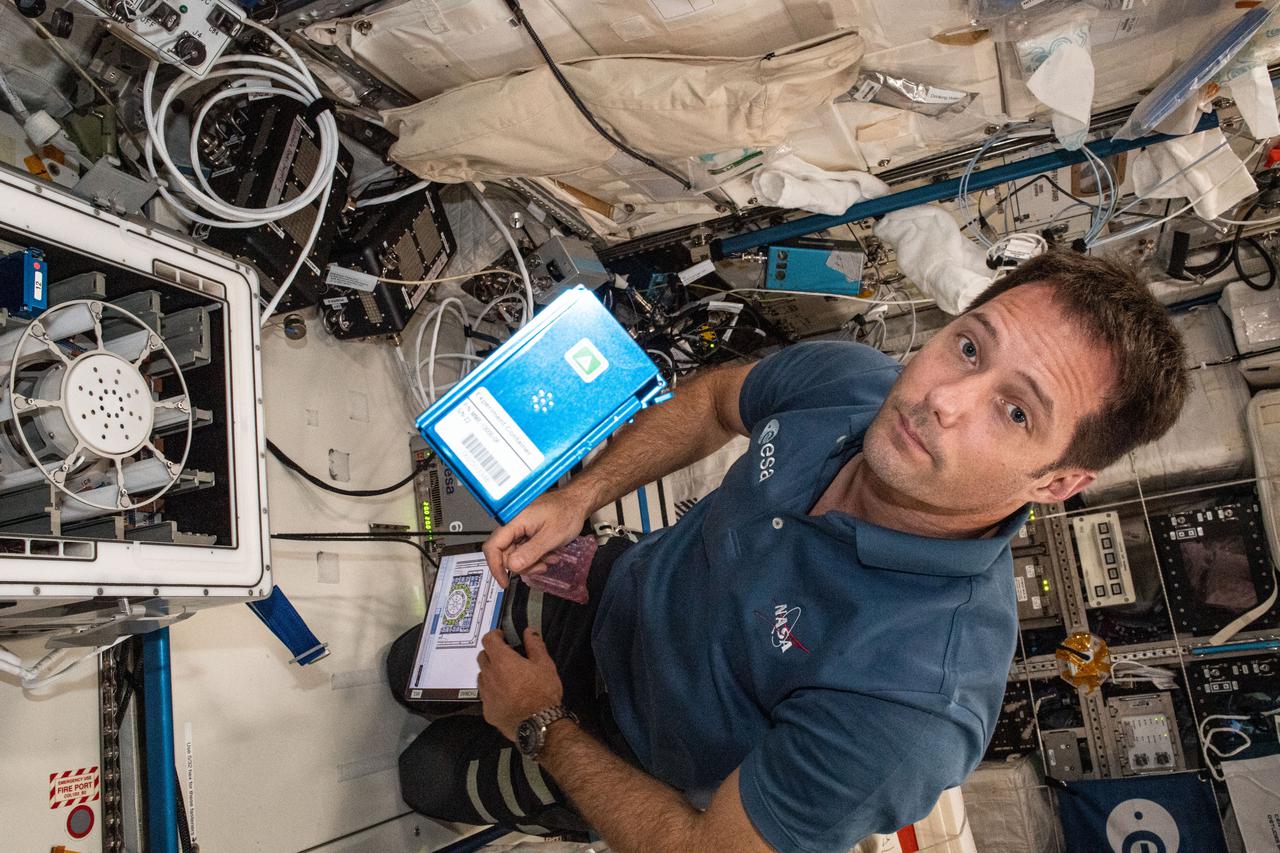 iss065e092399 (June 5, 2021) --- European Space Agency (ESA) astronaut Thomas Pesquet installs the Molecular Muscle Experiment-2 (MME-2) inside the Columbus laboratory module. MME-2 tests a series of drugs to see if they can improve health in space possibly leading to new therapeutic targets for examination on Earth.