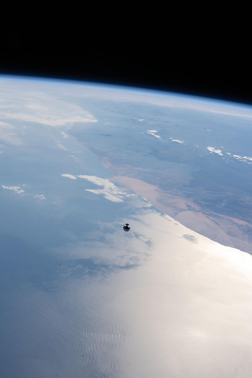 iss065e094357 (June 5, 2021) --- The SpaceX Cargo Dragon vehicle, on the SpaceX CRS-22 mission, approaches the International Space Station 265 miles above the Atlantic Ocean off the coast of Namibia on the African continent.