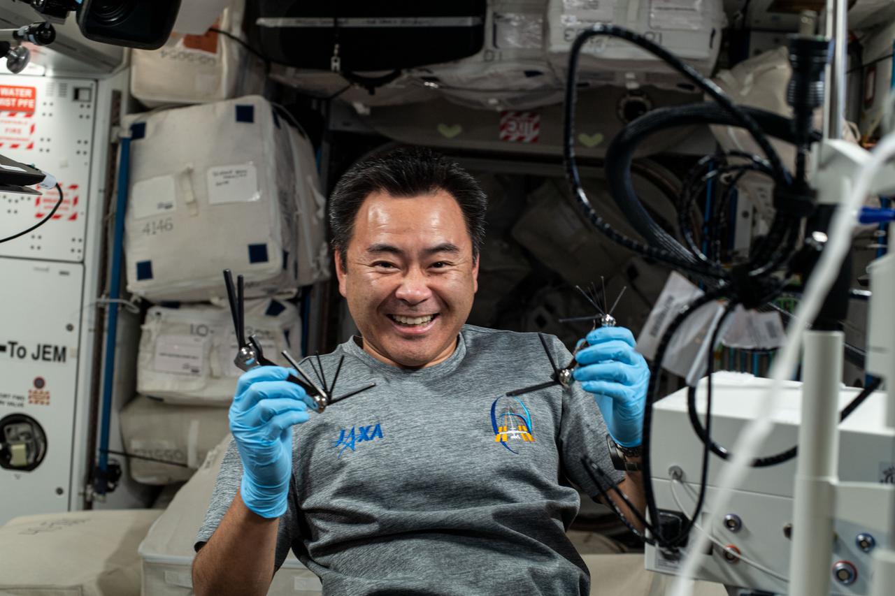 iss065e099700 (June 11, 2021) --- Expedition 65 Commander Akihiko Hoshide of the Japan Aerospace Exploration Agency is pictured displaying hardware he used to service medical imaging gear aboard the International Space Station.