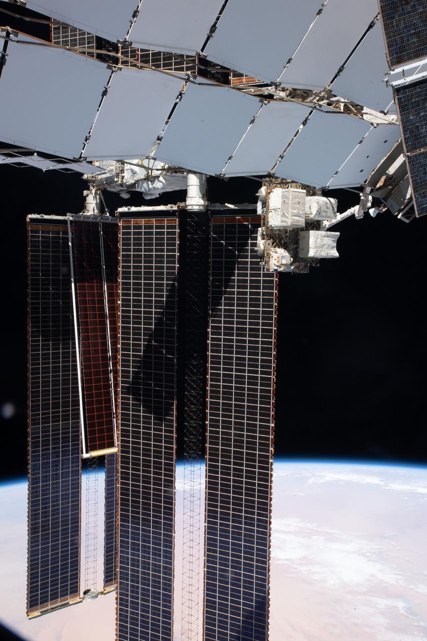 iss065e125924 (June 20, 2021) --- The new ISS Roll-Out Solar Array (iROSA) is deployed covering a portion of the main solar array on the International Space Station's P-6 truss structure. The iROSA and the main solar array are both connected to the truss segment's 2B power channel.
