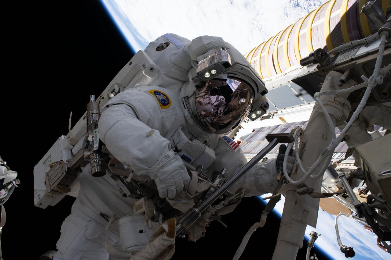 iss065e129879 (June 16, 2021) --- NASA spacewalker Shane Kimbrough is pictured during a spacewalk to install new roll out solar arrays on the International Space Station's Port-6 truss structure.