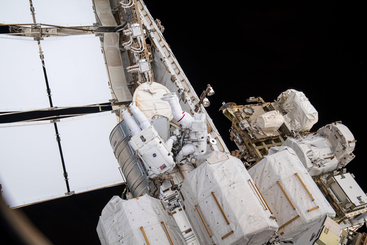 iss065e136980 (June 16, 2021) --- Spacewalkers (from left) Shane Kimbrough and Thomas Pesquet exit the U.S. Quest airlock to begin installing new roll out solar arrays on the International Space Station's Port-6 truss structure.