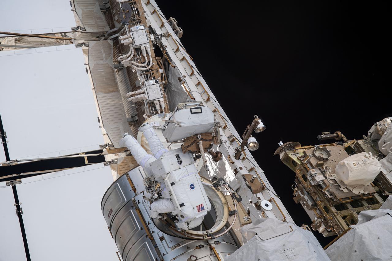 iss065e136998 (June 16, 2021) --- Spacewalkers (from left) Shane Kimbrough and Thomas Pesquet exit the U.S. Quest airlock to begin installing new roll out solar arrays on the International Space Station's Port-6 truss structure.