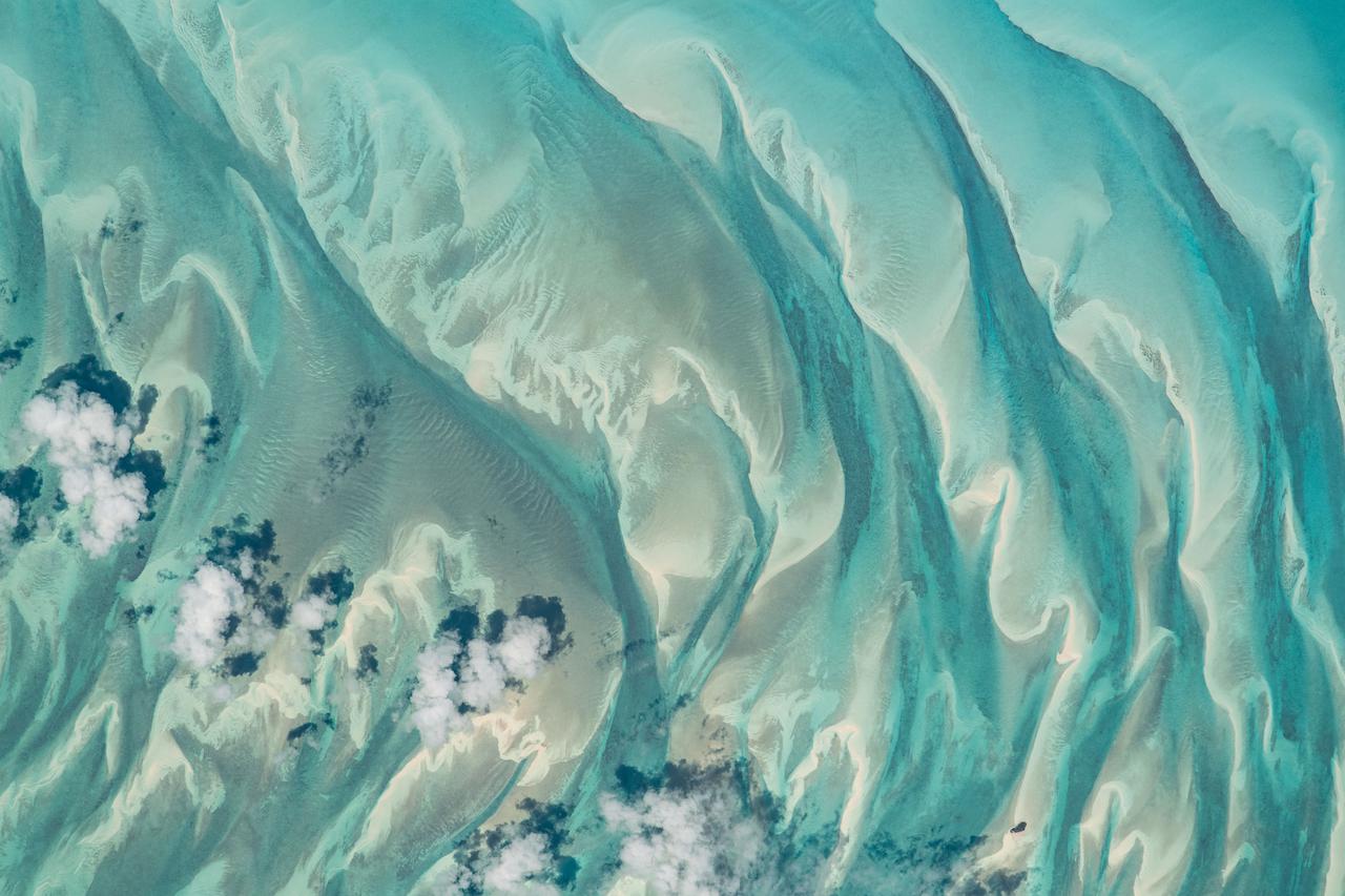 iss065e144117 (June 23, 2021) --- The shallow, clear blue waters off the coast of the Bahamas are pictured from the International Space Station as it orbited 260 miles above of the Atlantic Ocean.
