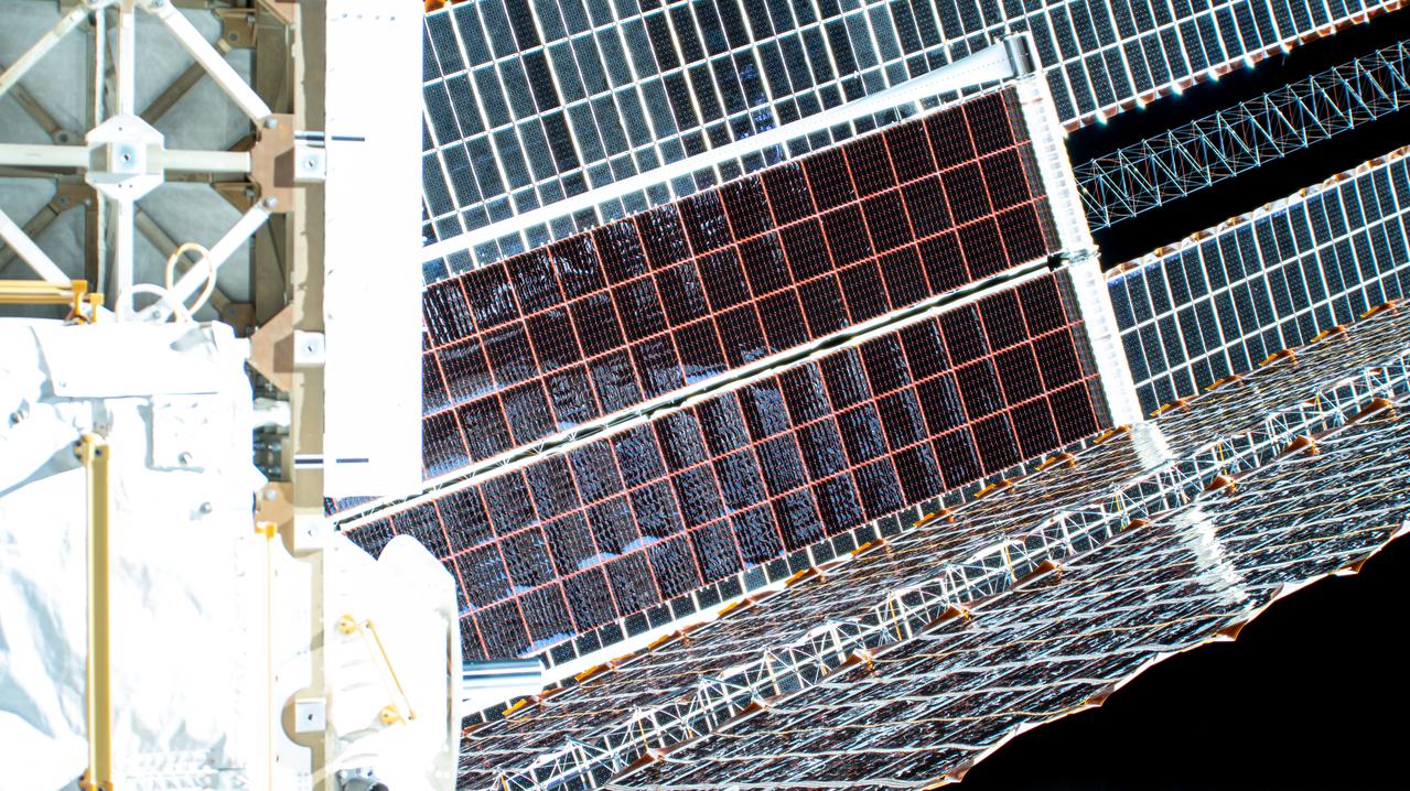 iss065e144542 (June 25, 2021) --- The second ISS Roll-Out Solar Array (iROSA) is pictured after completing its roll out on the International Space Station's Port-6 truss structure.