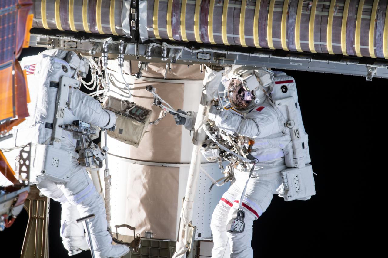 iss065e144867 (June 25, 2021) --- Spacewalkers (from left) Shane Kimbrough and Thomas Pesquet work to complete the installation of the second roll out solar array on the International Space Station's Port-6 truss structure.