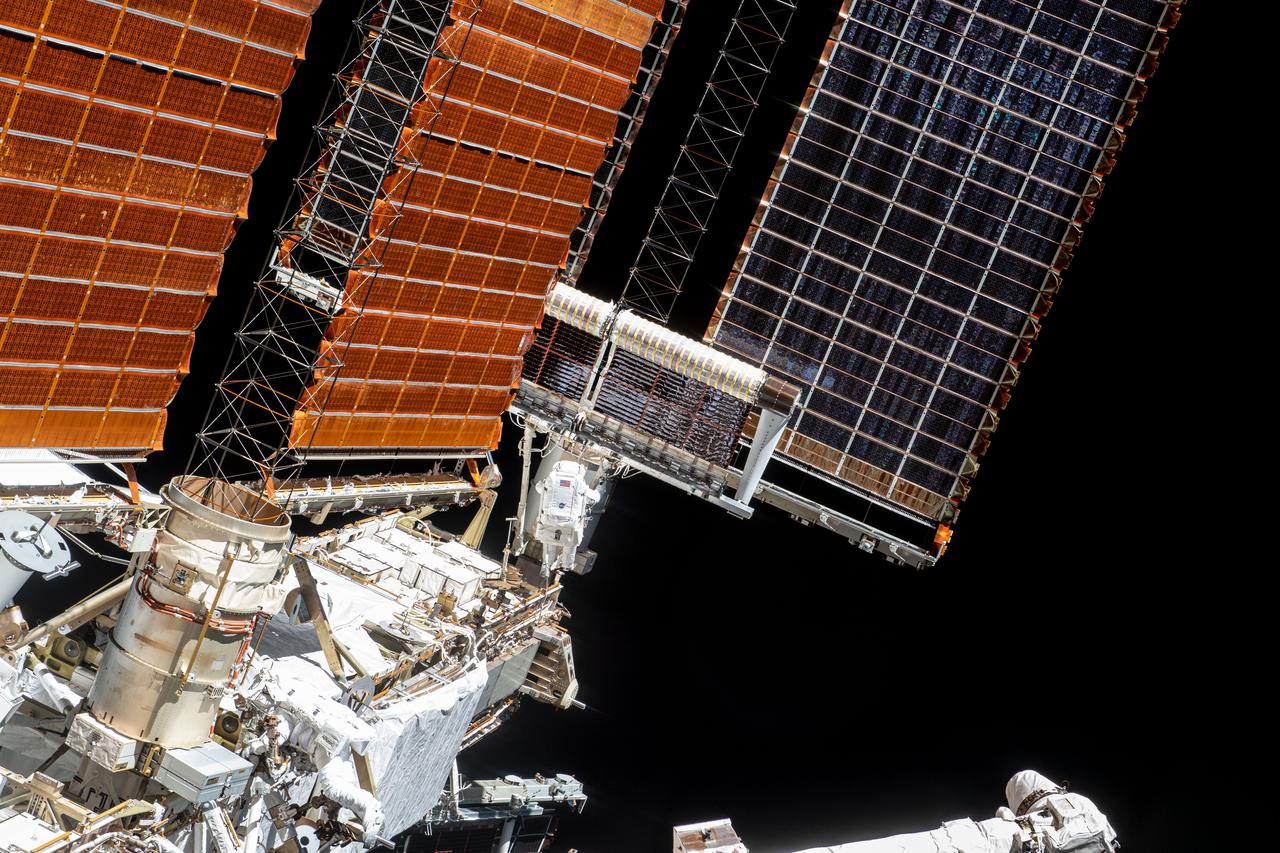 iss065e145092 (June 25, 2021) --- Spacewalker Thomas Pesquet of ESA (European Space Agency) is pictured at the base of the second roll out solar array as it began to roll out on the International Space Station's Port-6 truss structure
