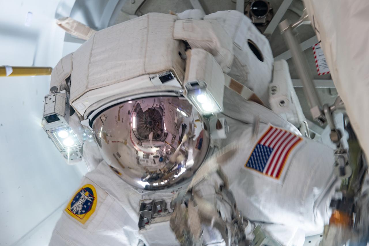 iss065e145103 (June 25, 2021) --- NASA spacewalker Shane Kimbrough is pictured in the U.S. Quest airlock after he and fellow spacewalker Thomas Pesquet of ESA (European Space Agency) completed the installation of the second roll out solar array on the International Space Station's Port-6 truss structure.