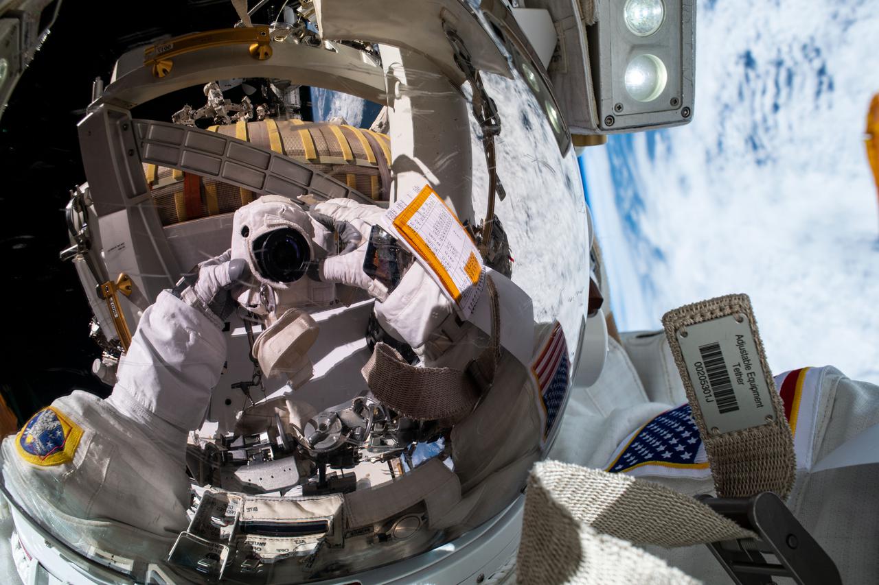 iss065e145170 (June 25, 2021) --- NASA spacewalker Shane Kimbrough took this "space-selfie" with the Earth behind him as he and fellow spacewalker Thomas Pesquet of ESA (European Space Agency) worked to complete the installation of the second roll out solar array on the International Space Station's Port-6 truss structure.